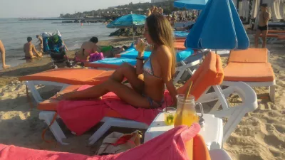 He Wants to See You in Your Bikini Because it&rsquo;s Step One in a Relationship : Woman on a deck chair on a sand beach