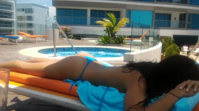 He Wants to See You in Your Bikini Because it&rsquo;s Step One in a Relationship : Woman taking the sun on the rooftop of a hotel nearby the jacuzzi in Radisson Blu Cartagena, Colombia